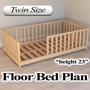 May include: A wooden twin-size floor bed plan with a slatted base and safety rails. The bed frame is light-colored wood, with a height of 23 inches. The text "Twin Size" and "Floor Bed Plan" are displayed.