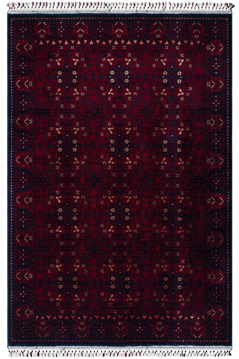 May include: A rectangular, patterned rug with a deep red and navy blue color scheme. The rug features a repeating geometric design with accents of gold. The edges are finished with a navy border and white fringe.