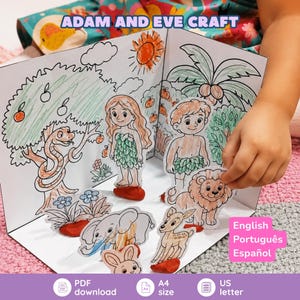 May include: A paper craft set titled ADAM AND EVE CRAFT featuring a foldable background with hand-coloured illustrations of trees, a snake, and a sun. Includes paper cutouts of two figures, a lion, an elephant, a deer, and a rabbit on clay bases.