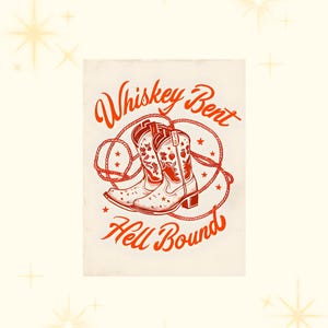 May include: A vintage-style graphic design with the text "Whiskey Bent Hell Bound" in red lettering. The design features a pair of red cowboy boots with floral embroidery, tied together with a lasso.
