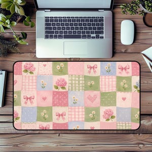 May include: A rectangular desk mat featuring a patchwork pattern of pastel squares in shades of pink, green, and blue. The design includes repeating illustrations of pink hydrangea flowers, white daisies, pink bows, small hearts, and various checkered or polka dot textures.