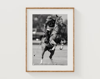 Puede incluir: Impresión enmarcada en blanco y negro de un partido de polo en acción. Un jinete a caballo está en pleno swing con un mazo, con las patas delanteras del caballo levantadas. La imagen captura el movimiento dinámico del deporte.