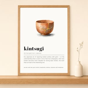 May include: Framed print featuring a watercolor illustration of a kintsugi bowl, a Japanese art form. The bowl is a warm brown color with gold accents. The word "kintsugi" is printed below the bowl, along with a description.