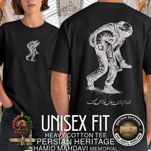 May include: A black short-sleeve t-shirt featuring a white graphic on the back of one person carrying another on their back, with Persian script below. A smaller version of the same graphic is printed on the front left chest area of the shirt.