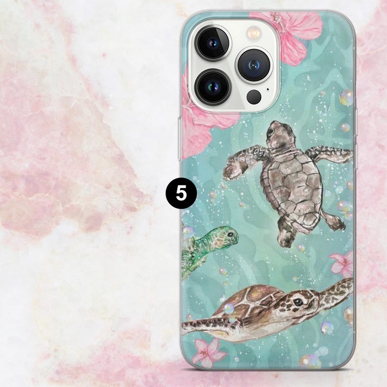 May include: A clear phone case featuring a watercolor design of sea turtles swimming in turquoise water with pink flowers. The case has a glossy finish and a protective bumper around the edges.