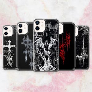 May include: A collection of five phone cases with gothic-inspired designs. The cases feature black backgrounds with white and red graphic illustrations, including crosses, angel figures, and ornate patterns. The cases are made of clear plastic.