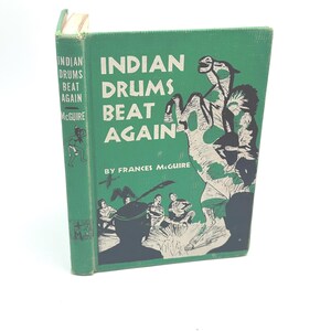 May include: A vintage hardcover book titled "Indian Drums Beat Again" by Frances McGuire. The cover is green with black and white illustrations of Native Americans and the title in large white letters. The book is in good condition.
