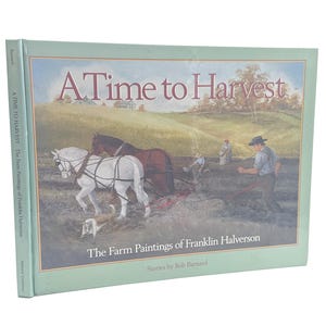 Op de afbeelding: Een hardcover boek getiteld "A Time to Harvest" met een pastorale schildering. De omslag toont een boer die een veld ploegt met paarden, met de tekst "The Farm Paintings of Franklin Halverson" en "Stories by Bob Barnard".