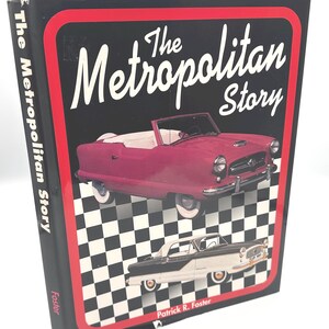 May include: A hardcover book titled The Metropolitan Story by Patrick R. Foster. The black cover features a red border, a checkered pattern, and illustrations of two vintage convertible cars, one in magenta and one in black and white.