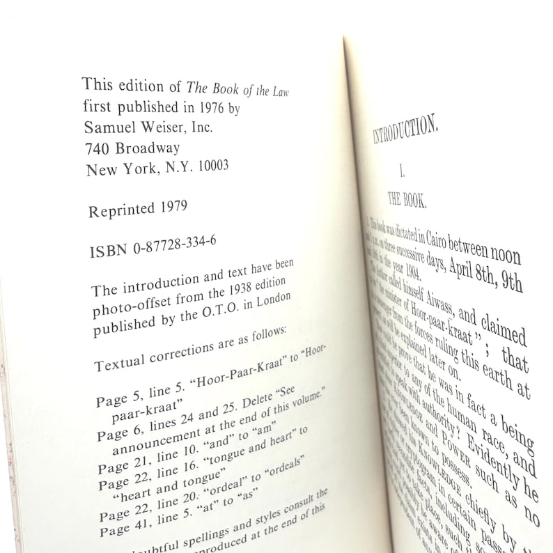 May include: Open book with text from "The Book of the Law" published in 1976 by Samuel Weiser, Inc. The book's introduction and text are photo-offset from the 1938 edition. Textual corrections are listed on the left page.