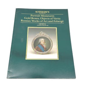 May include: A dark green Sotheby's auction catalog from Thursday, May 14, 1987, in Geneva. The cover features gold text titled Portrait Miniatures, Gold Boxes, Objects of Vertu, Russian Works of Art and Fabergé, with a central oval portrait.