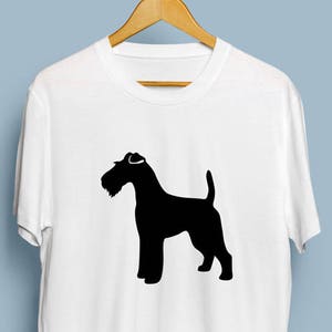 May include: White t-shirt with a black silhouette of a Wirehaired Fox Terrier dog.