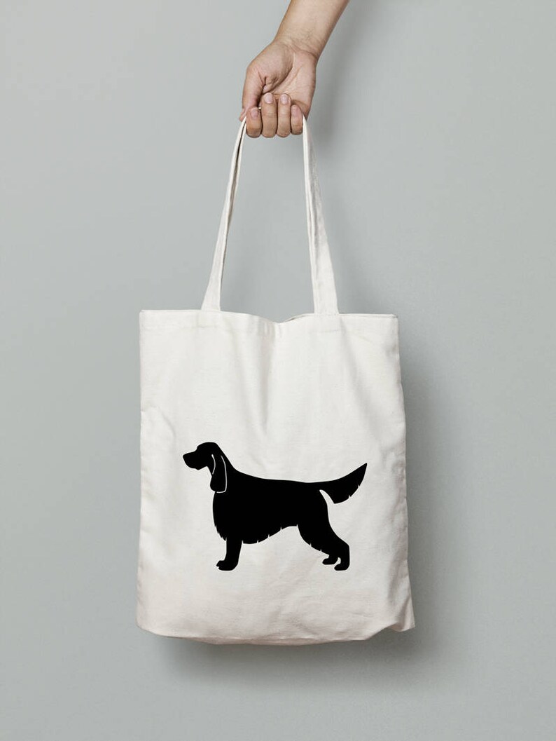 May include: A white canvas tote bag with a black silhouette of an Irish Setter dog.