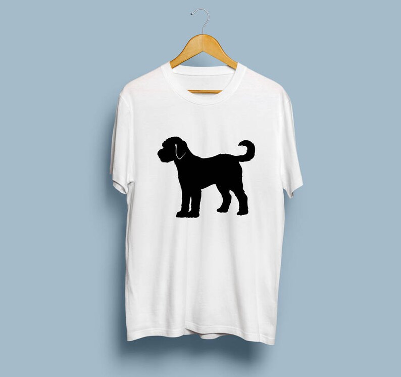 May include: White t-shirt with a black silhouette of a dog on the front.