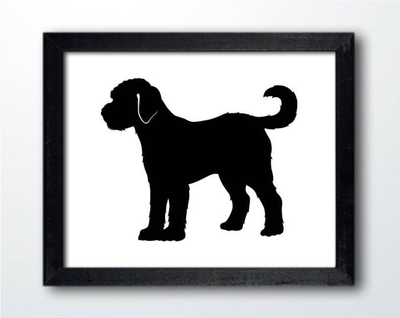 May include: Black silhouette of a dog with a curly tail, standing on a white background. The dog is facing to the left, with its head turned slightly to the right. The silhouette is framed by a black frame.