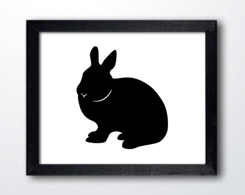 May include: Black silhouette of a rabbit sitting on a white background. The rabbit is facing the left side of the image.
