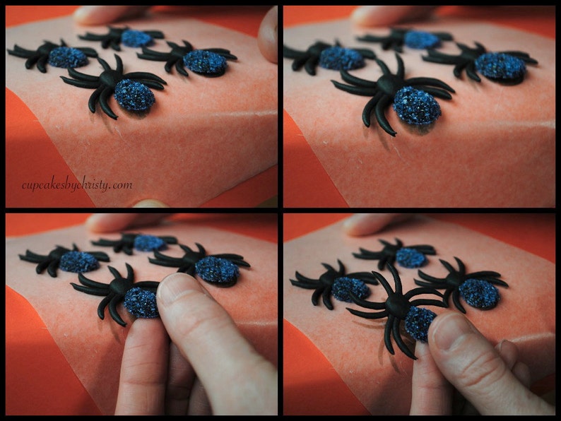 May include: Black spider decorations with blue glitter bodies are arranged on a light orange surface. The image shows the process of placing the spiders. The website address cupcakesbychristy.com is visible in the image.