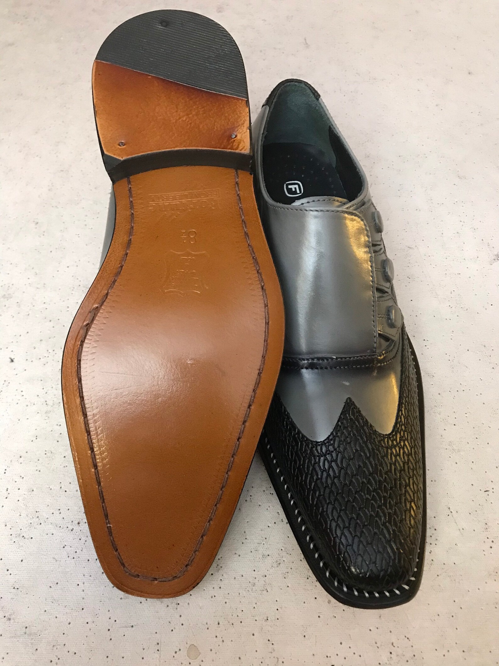 black and grey wingtip shoes