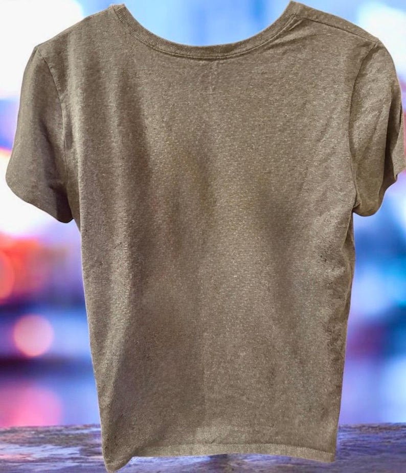 May include: A short-sleeved, crew neck t-shirt in a muted, earthy brown colour. The shirt has a simple, classic design, with a rounded neckline and short sleeves. The fabric appears to be soft and lightweight.