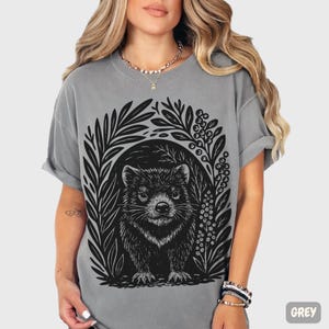 Hand-carved linocut Tasmanian Devil illustration with stylized foliage, minimalist wildlife art printed on cotton t-shirt