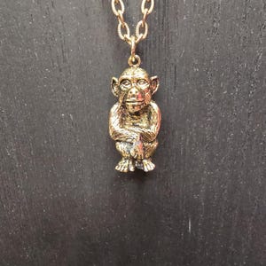 Vintage Brass Monkey pendant on chain necklace.