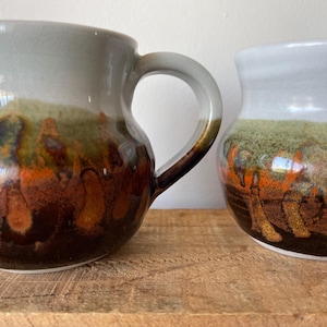 May include: A white-painted wooden 'Welcome' sign with a distressed finish and a floral design in pink and green. The sign, suitable for indoor or outdoor use, features the word 'Welcome' in a whimsical font, adding a welcoming touch.