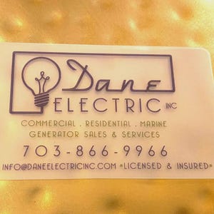 May include: A rectangular, semi-translucent business card featuring the black text Dane Electric Inc, a lightbulb icon, and the services: Commercial, Residential, Marine, Generator Sales & Services, phone number 703-866-9966, email, and Licensed & Insured.