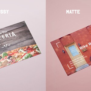 May include: Two rectangular cards with different finishes. The left card is glossy, featuring a pizza image and text reading All Our Pies PIZZERIA WOOD FIRED PIZZA. The right card is matte, showing a red brick building and text reading Bike Ride Day.