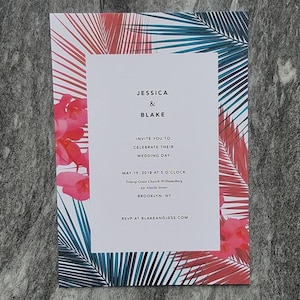 May include: A rectangular wedding invitation card featuring a white center panel with black text reading Jessica & Blake, invite you to celebrate their wedding day, May 19, 2018 at 5 o'clock, Trinity Grace Church Williamsburg, 231 Ainslie Street, Brooklyn, NY, RSVP at blakeandjess.com, surrounded by a border of pink orchids and teal and red palm fronds.