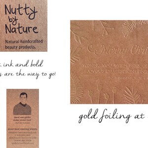 May include: A collection of brown paper tags and cards featuring various designs. One tag shows a red acorn illustration with the text Nutty by Nature. Another card displays gold foil embossed Merry Christmas text with botanical patterns.