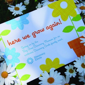 May include: A rectangular white card featuring the orange text here we grow again! and additional event details for the Bay Area Discovery Museum. The card is decorated with blue and yellow flower illustrations and an orange patterned flower pot.