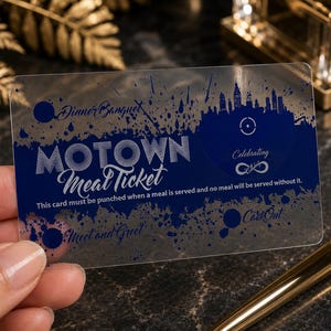 Puede incluir: Una tarjeta rectangular de pl&aacute;stico semitransparente con un dise&ntilde;o de tinta azul oscuro. El texto dice Motown Meal Ticket, Dinner Banquet, Celebrating, Meet and Greet, CartOut y This card must be punched when a meal is served and no meal will be served without it.