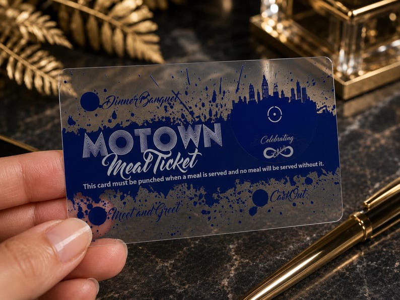 Puede incluir: Una tarjeta rectangular de pl&aacute;stico semitransparente con un dise&ntilde;o de tinta azul oscuro. El texto dice Motown Meal Ticket, Dinner Banquet, Celebrating, Meet and Greet, CartOut y This card must be punched when a meal is served and no meal will be served without it.