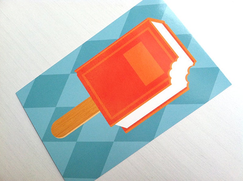 May include: A rectangular sticker featuring a graphic illustration of an orange popsicle with a white cream center and a wooden stick. The popsicle has a bite mark on the right side. The background consists of a light blue geometric diamond pattern.