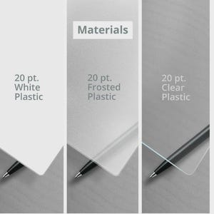 May include: Three rectangular plastic sheets labeled Materials. The first is 20 pt. White Plastic, the second is 20 pt. Frosted Plastic, and the third is 20 pt. Clear Plastic. Each sheet is partially overlapping a black pen tip at the bottom corner.