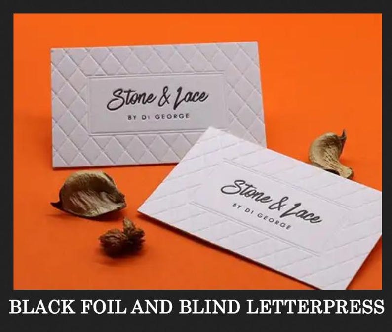 May include: Two rectangular white business cards featuring a blind letterpress diamond pattern and the black text Stone & Lace BY DI GEORGE. The cards are displayed against a solid orange background with small dried botanical elements nearby.