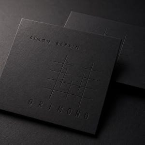 May include: Two square matte black business cards featuring debossed text and graphics. The top text reads SIMON BERLIN, and the bottom text reads ORIMONO. A central graphic consists of a series of intersecting horizontal and vertical lines.