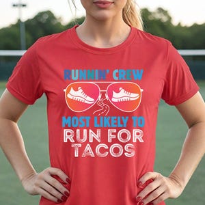 May include: Red t-shirt with the text "RUNNIN' CREW MOST LIKELY TO RUN FOR TACOS". The design includes sunglasses with running shoes inside the lenses. The shirt is being worn by a person.