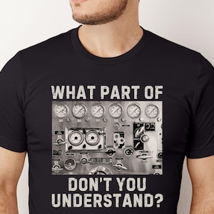 May include: Black t-shirt with a white graphic of a control panel with gauges and the text "WHAT PART OF DON'T YOU UNDERSTAND?"
