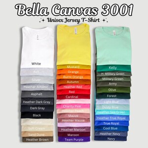 May include: A display of Bella Canvas 3001 Unisex Jersey T-shirts in various colors, including white, yellow, and mint. Color options are listed below each shirt, such as Ash, Mustard, and Kelly. The image showcases a range of hues.
