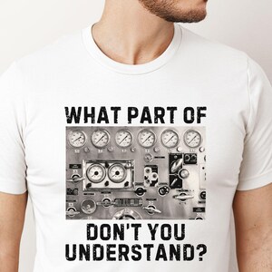 May include: White t-shirt with a black and white graphic of a control panel with gauges and the text "WHAT PART OF DON'T YOU UNDERSTAND?"