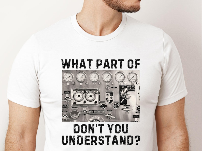 May include: White t-shirt with a black and white graphic of a control panel with gauges and the text "WHAT PART OF DON'T YOU UNDERSTAND?"