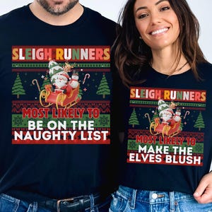 May include: Navy blue t-shirts with a Christmas design. The shirts feature the text "SLEIGH RUNNERS" and "MOST LIKELY TO BE ON THE NAUGHTY LIST" and "MOST LIKELY TO MAKE THE ELVES BLUSH" with a Santa Claus and snowman in a sleigh.