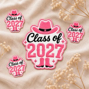 May include: Pink and white embroidered patches with a cowboy hat and boots design. The patches feature the text "Class of 2027" in black script. The patches are in various sizes and shapes, with a star and floral design.