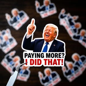 May include: A collection of stickers featuring a laughing man in a suit and tie, with the text "PAYING MORE? I DID THAT!". The stickers are white with a black border and are scattered on a dark wooden surface.