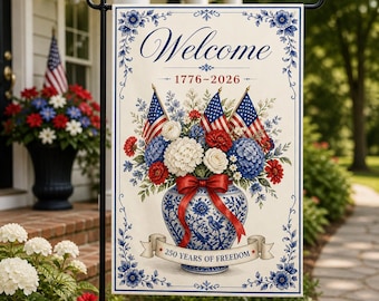 May include: A decorative garden flag with a patriotic theme. It features a floral arrangement with American flags, red, white, and blue flowers in a blue and white vase. The flag reads "Welcome" and "250 Years of Freedom."