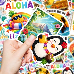 May include: A hand holding a collection of colorful tropical-themed stickers. The stickers feature images of a pineapple wearing sunglasses, a penguin with a lei, and tropical landscapes. The word "ALOHA" is visible in rainbow colors.