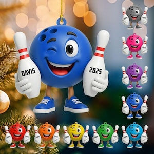 May include: A blue bowling ball ornament with a winking face, holding a bowling pin that says "2025" and another pin that says "DAVIS". Additional bowling ball ornaments in various colors are also shown.