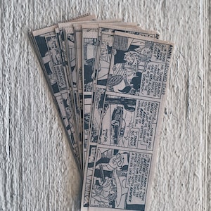 May include: A stack of vintage comic books with black and white illustrations. The comic book covers feature text that reads "Annie/Leonard Starr" and "Warbucks, Sir... Y' think 50, Boy?"