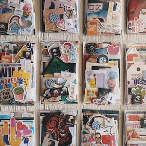 May include: Nine clear plastic envelopes filled with colorful paper scraps, stickers, and ephemera. The envelopes are arranged in three rows of three. The envelopes are all different sizes and shapes. The paper scraps are all different colors and patterns. The stickers are all different shapes and sizes. The ephemera is all different types and sizes.